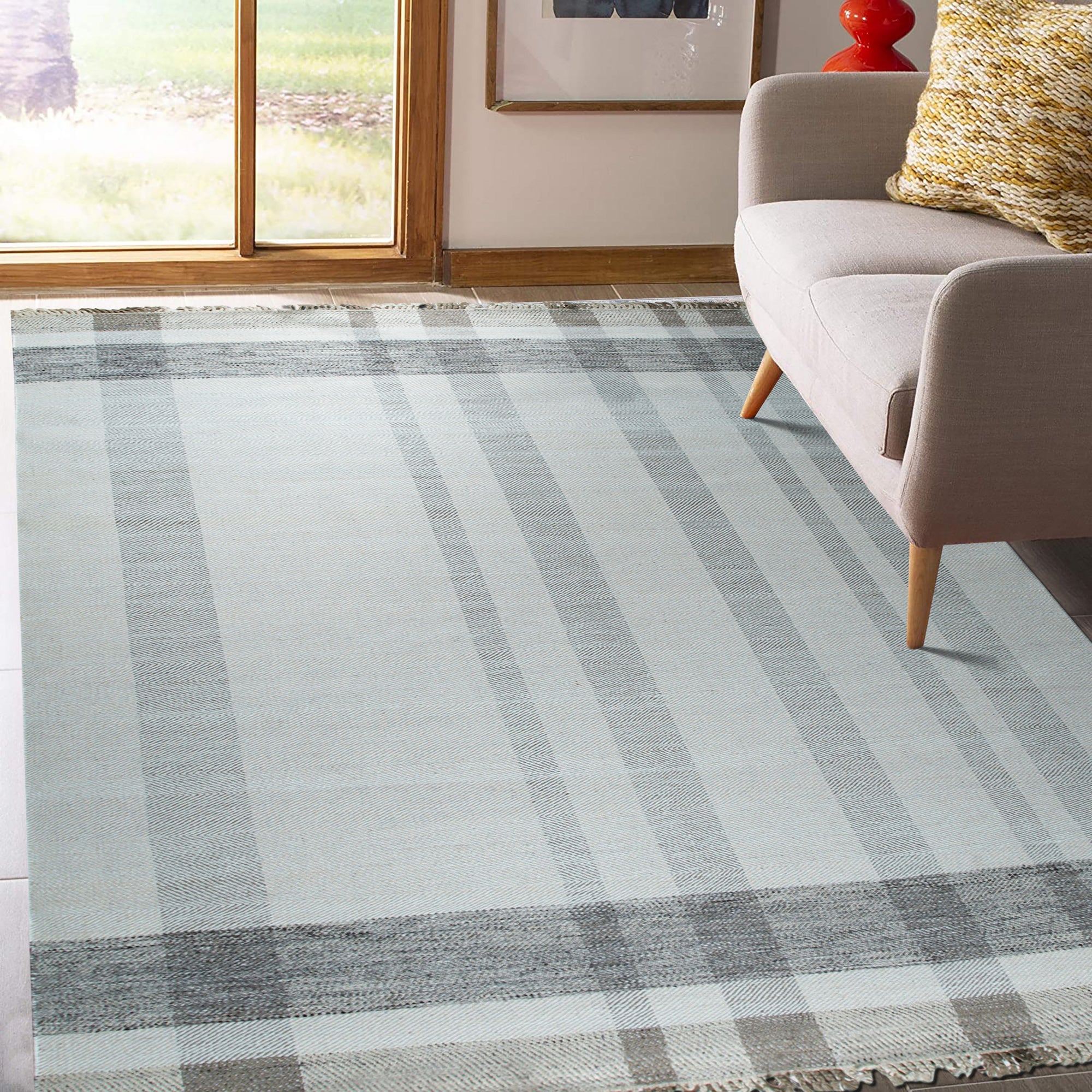Giselle Serene Multicolor Flatweave Wool Rug, vibrant blues, reds, yellows, and greens intertwine in a contemporary geometric pattern, showcasing its flatweave construction and adding a splash of modern artistry to the room.