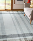 Giselle Serene Multicolor Flatweave Wool Rug, vibrant blues, reds, yellows, and greens intertwine in a contemporary geometric pattern, showcasing its flatweave construction and adding a splash of modern artistry to the room.