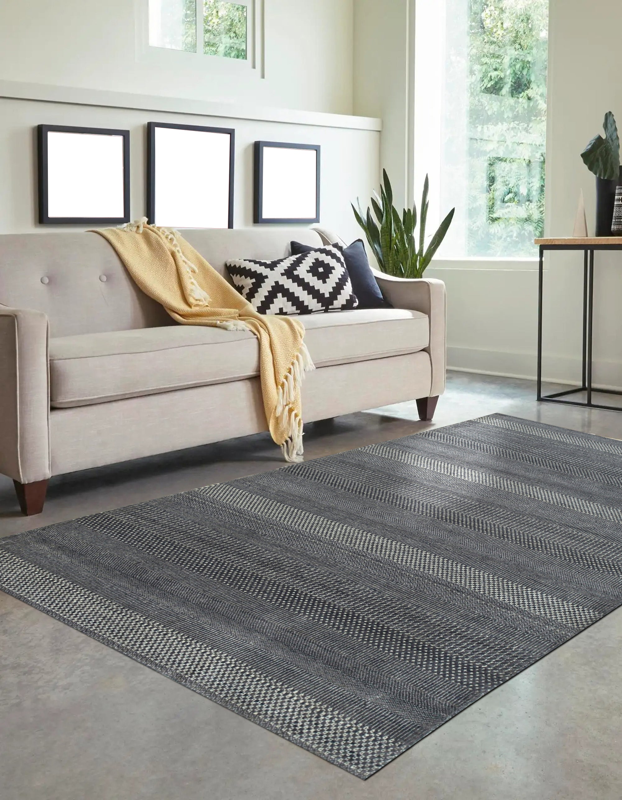 Dazzling Chic Gray Hand Knotted Wool & Viscose Rug, a gray wool and viscose rug with a shimmering sheen and subtle geometric pattern, displayed in a bright living room setting.