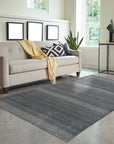 Dazzling Chic Gray Hand Knotted Wool & Viscose Rug, a gray wool and viscose rug with a shimmering sheen and subtle geometric pattern, displayed in a bright living room setting.