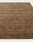 Ruby Inviting Brown Machine Made Wool Rug, a warm, inviting brown wool rug with a subtle, textured design, partially visible in a well-lit room setting.