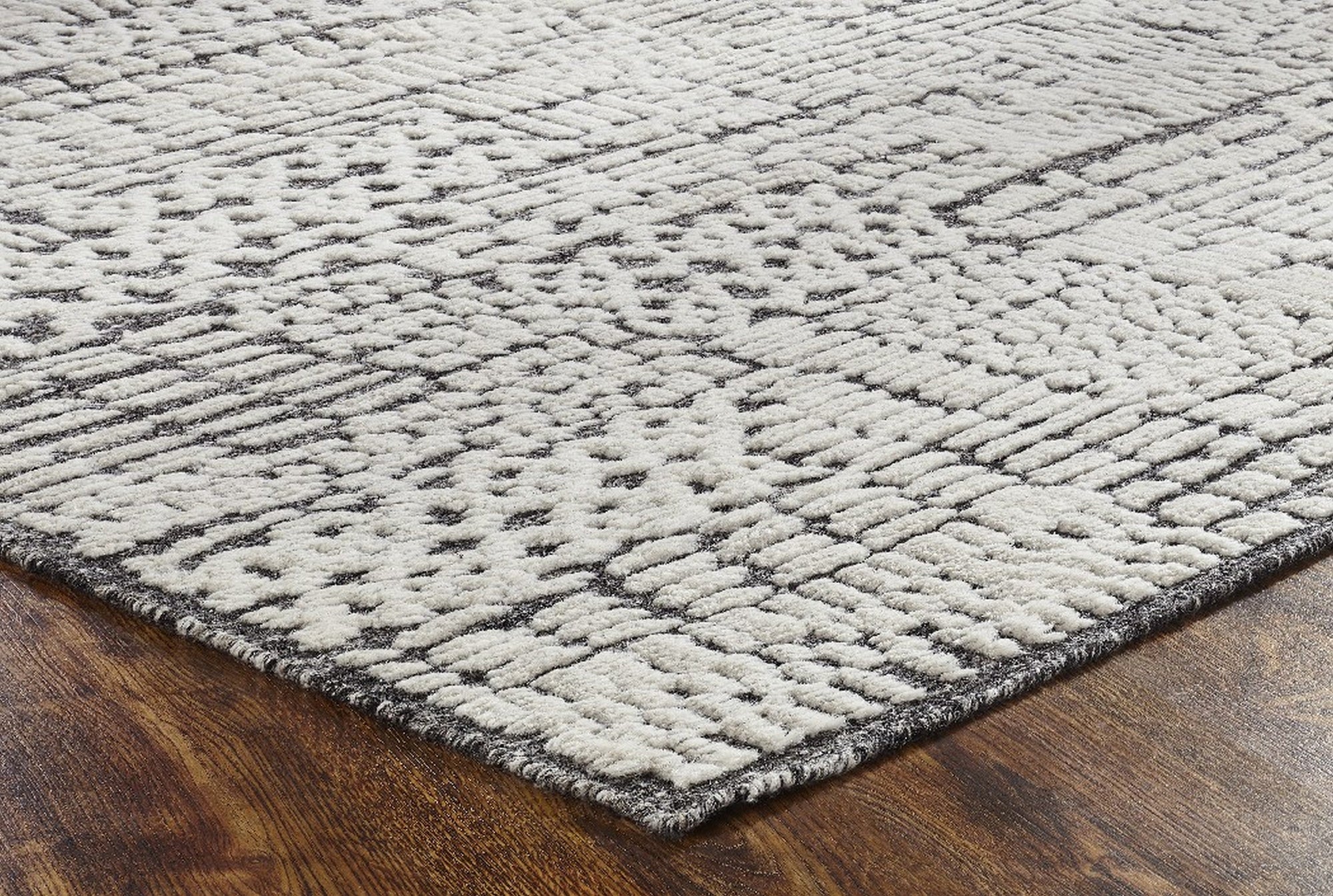 Sloane Sophisticated Ivory Hand Knotted Wool Rug, showcasing a calming ivory palette and intricate, hand-knotted construction, complements a softly lit living space with its luxurious texture.
