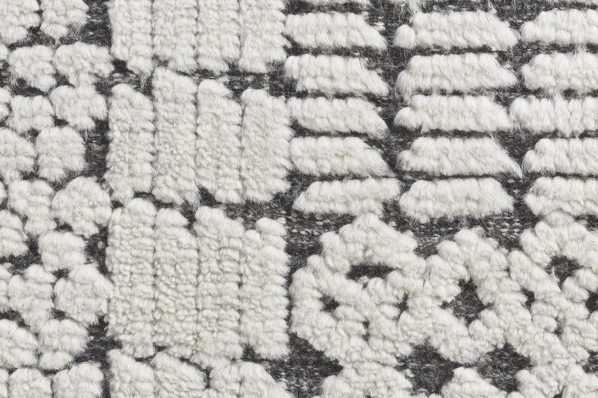 Sloane Sophisticated Ivory Hand Knotted Wool Rug, its soft ivory tones and intricate hand-knotted construction evident in a room setting.