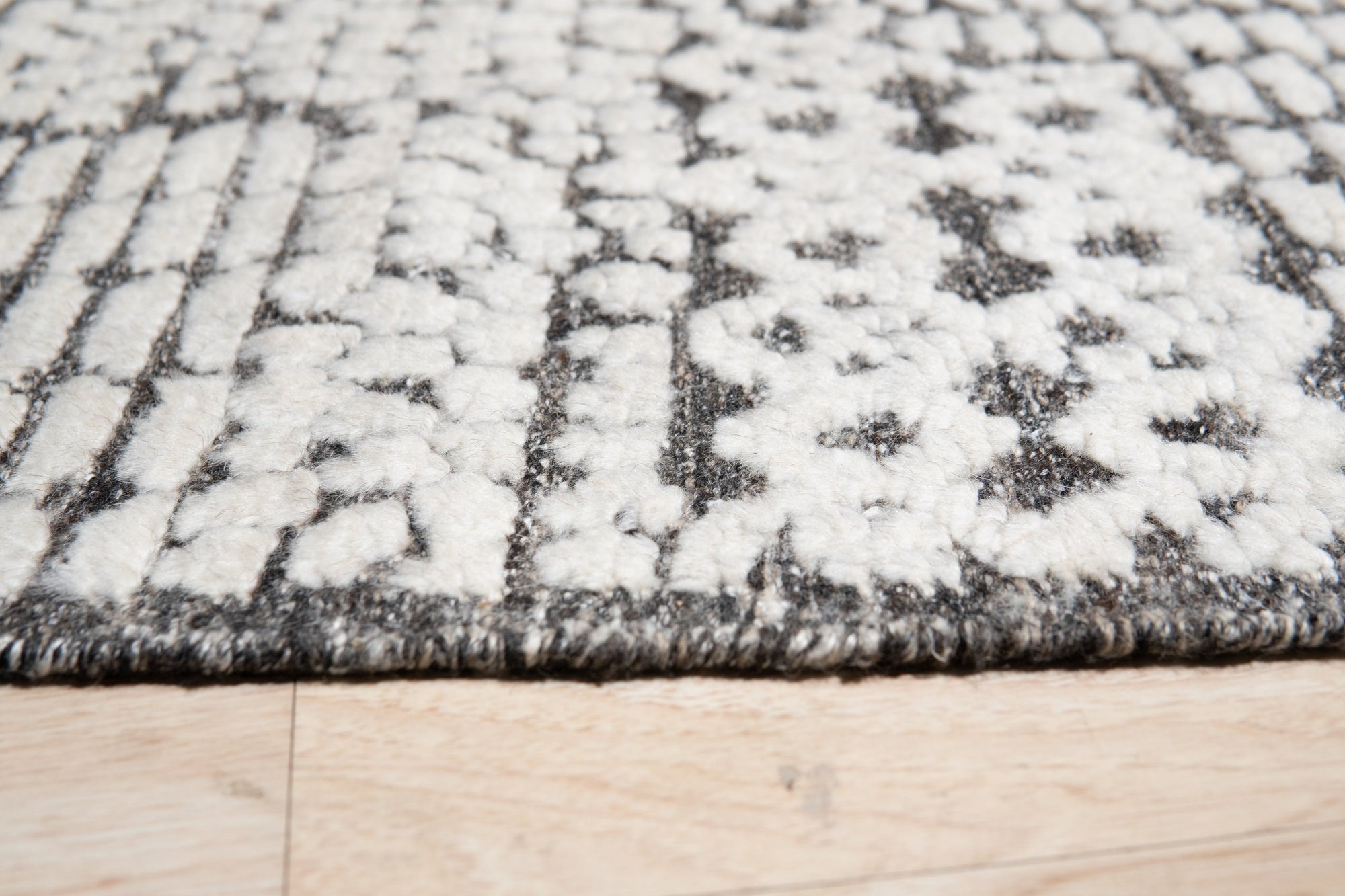 Sloane Sophisticated Ivory Hand Knotted Wool Rug, its soft ivory tones and hand-knotted texture adding warmth to a modern living space.