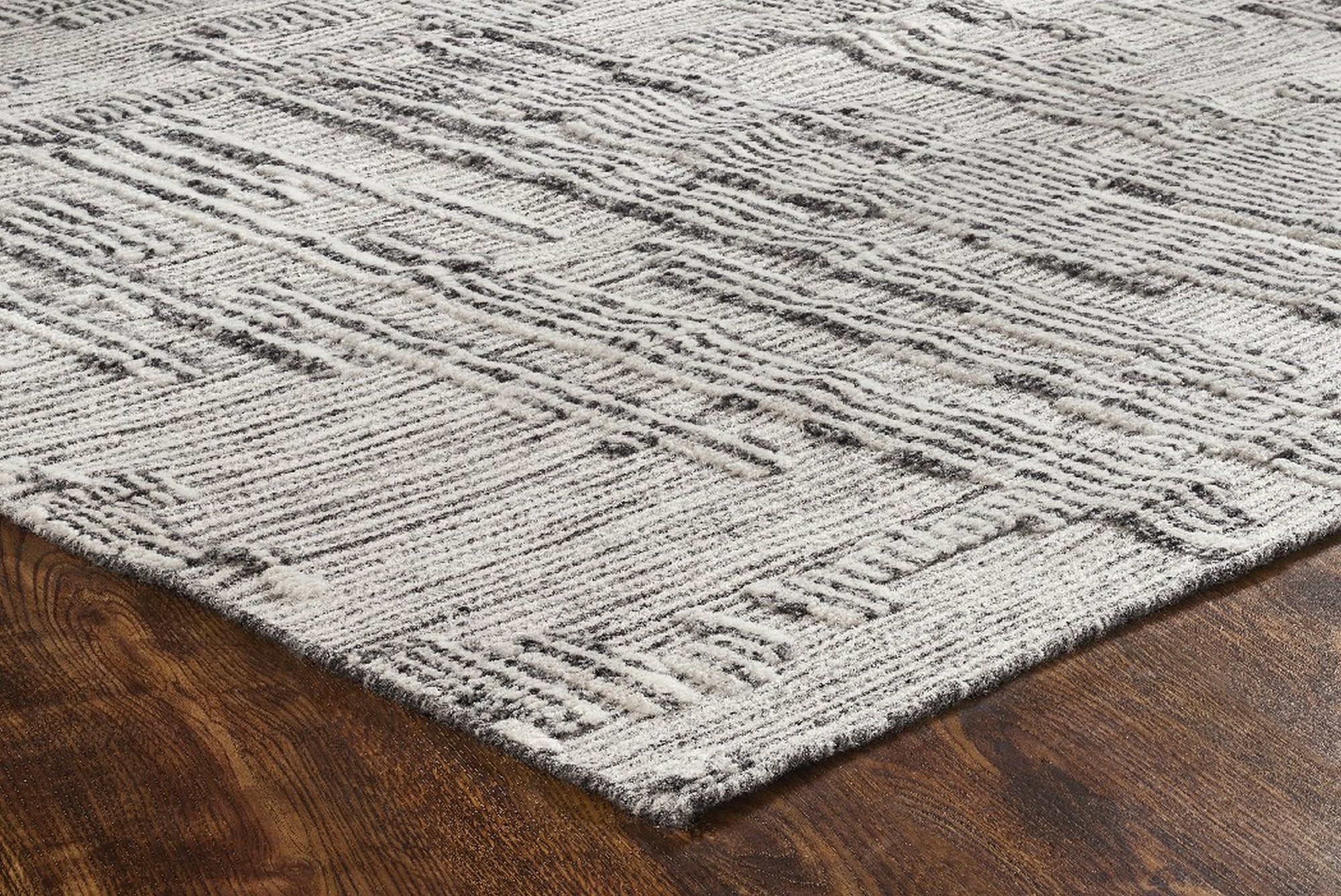 Lush Xena Ivory Handmade Wool Rug displayed in a cozy living room setting. Soft, hand-tufted wool rug offers texture and warmth underfoot, its ivory hue complementing the neutral décor and creating a serene, inviting atmosphere.