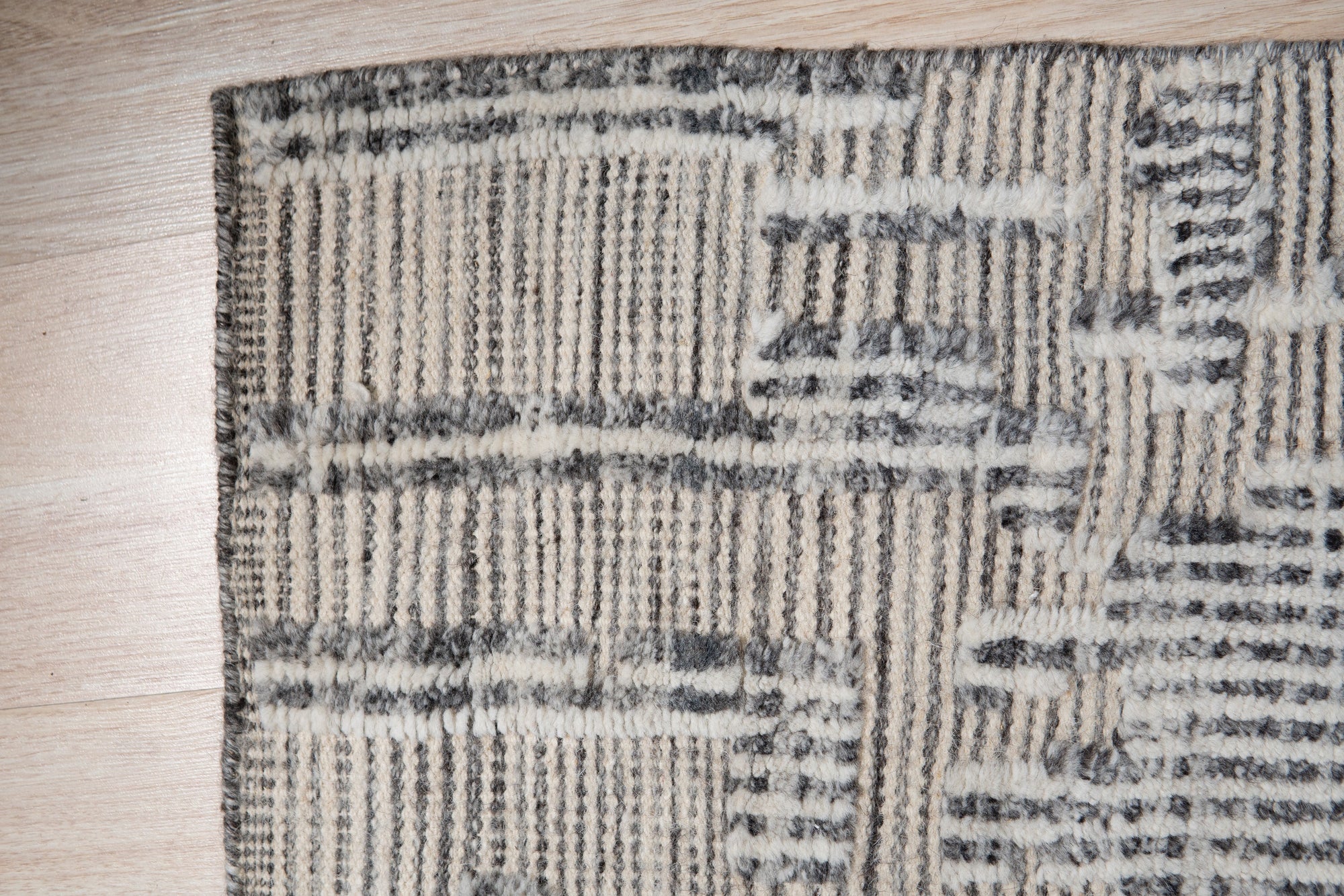 Lush Xena Ivory Handmade Wool Rug, showcasing its plush texture and subtle ivory tones, softens a modern living space with neutral decor and natural light.