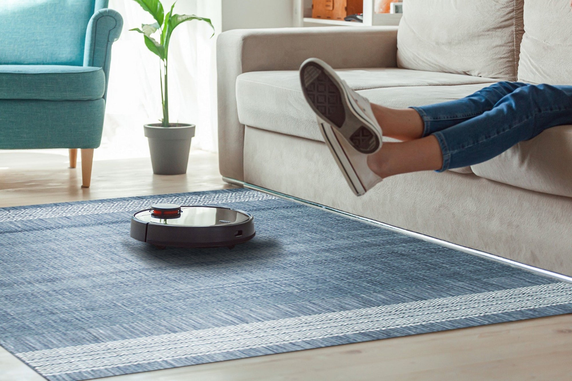 Delicate Elena Blue Flatweave Wool Rug, a cool-toned, flatweave rug with subtle geometric patterns in varying shades of blue, seen in a well-lit interior setting.
