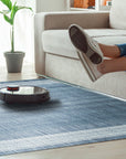 Delicate Elena Blue Flatweave Wool Rug, a cool-toned, flatweave rug with subtle geometric patterns in varying shades of blue, seen in a well-lit interior setting.