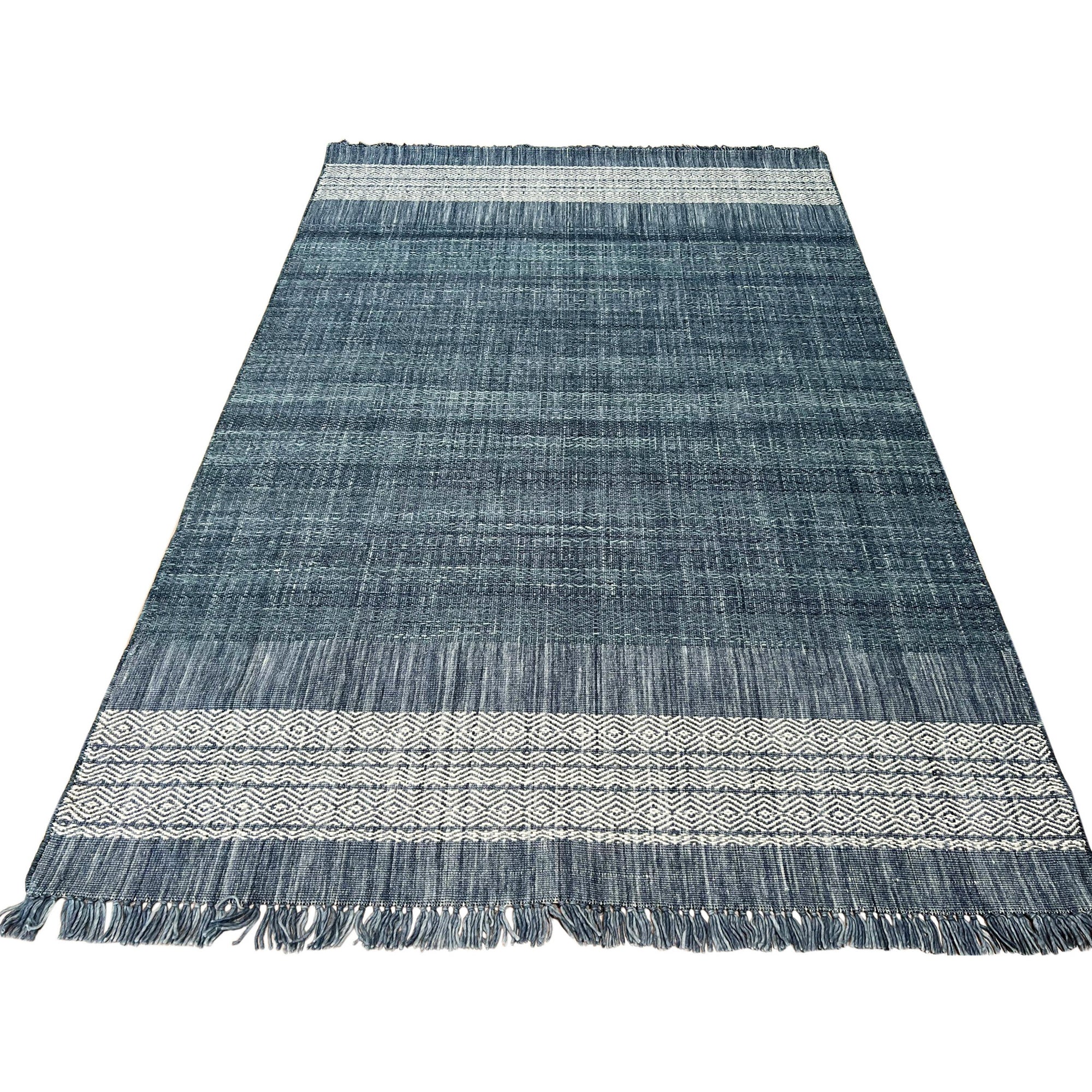 Delicate Elena Blue Flatweave Wool Rug, seen in a bright, inviting space; its flatweave construction and subtle blue hues add a touch of understated elegance.