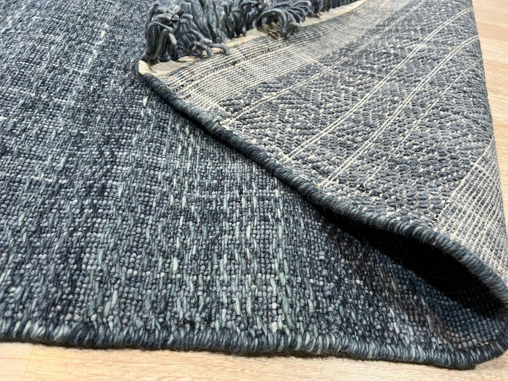 Delicate Elena Blue Flatweave Wool Rug, a calming blue wool rug with a subtle, textured flatweave design, adding warmth to a modern living space.