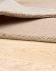 Vibrant Kira Beige Handmade Wool Rug, a textured beige wool rug with geometric patterns, grounding a modern living space with warm tones and subtle design.
