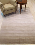 Vibrant Kira Beige Handmade Wool Rug, a warm beige wool rug with a subtly patterned design, complements a modern living space with light wood flooring and neutral furniture.