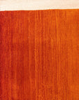 Ruby Classic Orange Handmade Wool Rug, warm orange tones blend in a detailed traditional pattern, a luxurious wool pile showcasing intricate craftsmanship in a room setting.