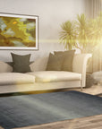 Modern Talia Gray Handmade Wool Rug graces a contemporary living room, its soft gray wool providing a grounding element beneath a light wood coffee table and a minimalist sofa. The rug's subtle, geometric pattern adds visual texture without overwhelming the space.