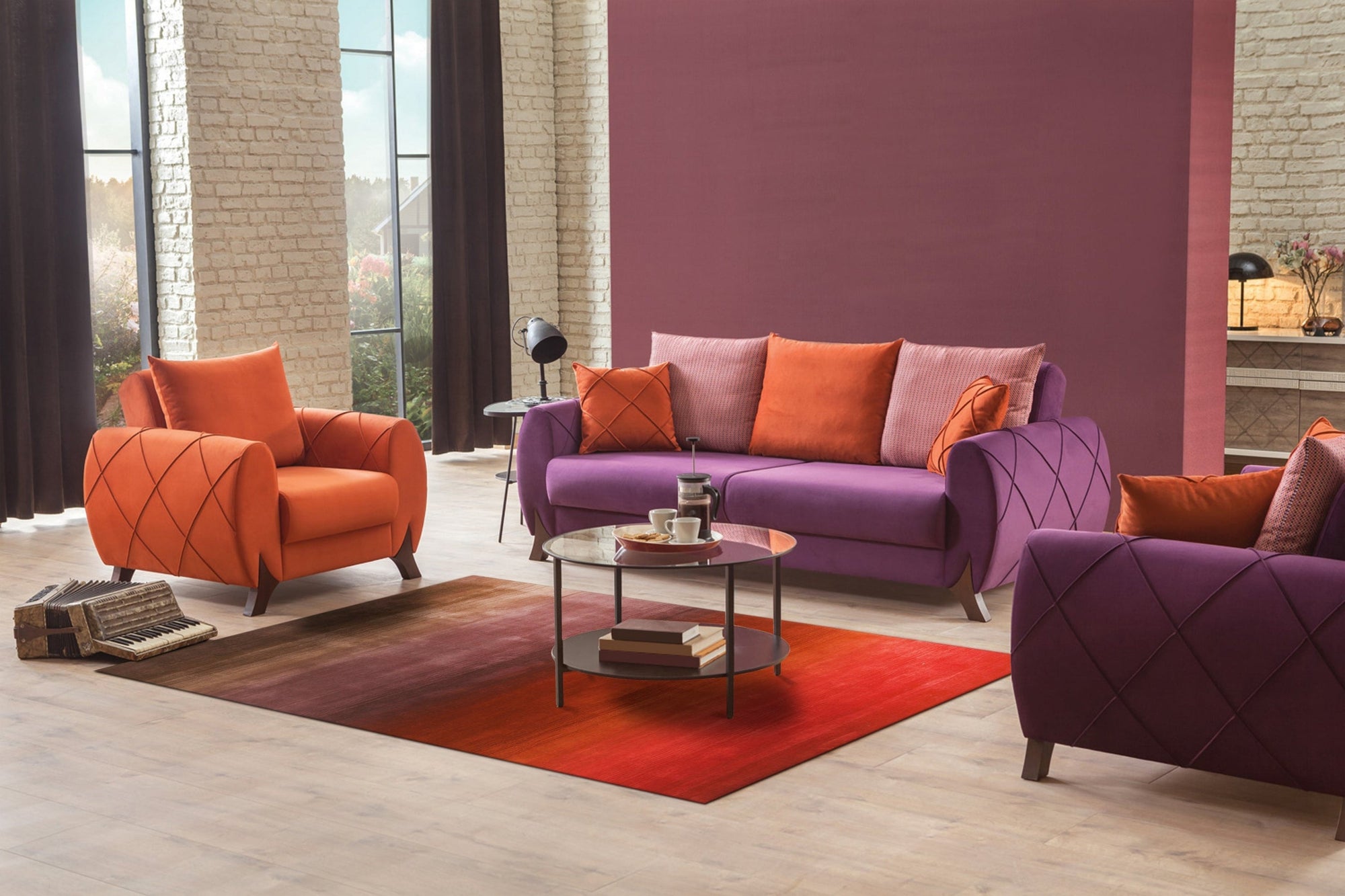 Rhea Unique Multicolor Handmade Wool Rug, filling a modern living space with vibrant, geometric patterns in shades of blue, orange, and cream. Light wood floors and a minimalist sofa complement the rug's bold design.