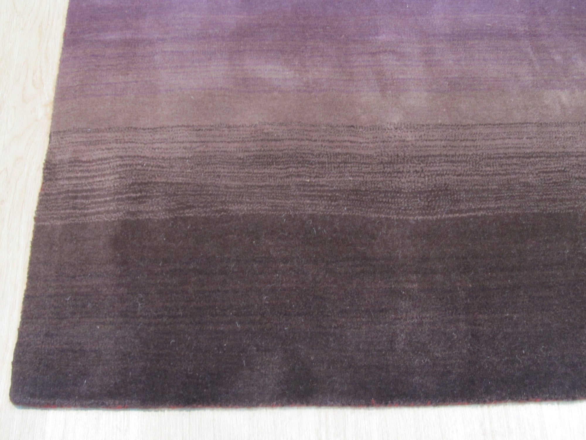 Rhea Unique Multicolor Handmade Wool Rug, showcasing vibrant hues and intricate patterns; a burst of handcrafted warmth and artistry in a sunlit room setting.