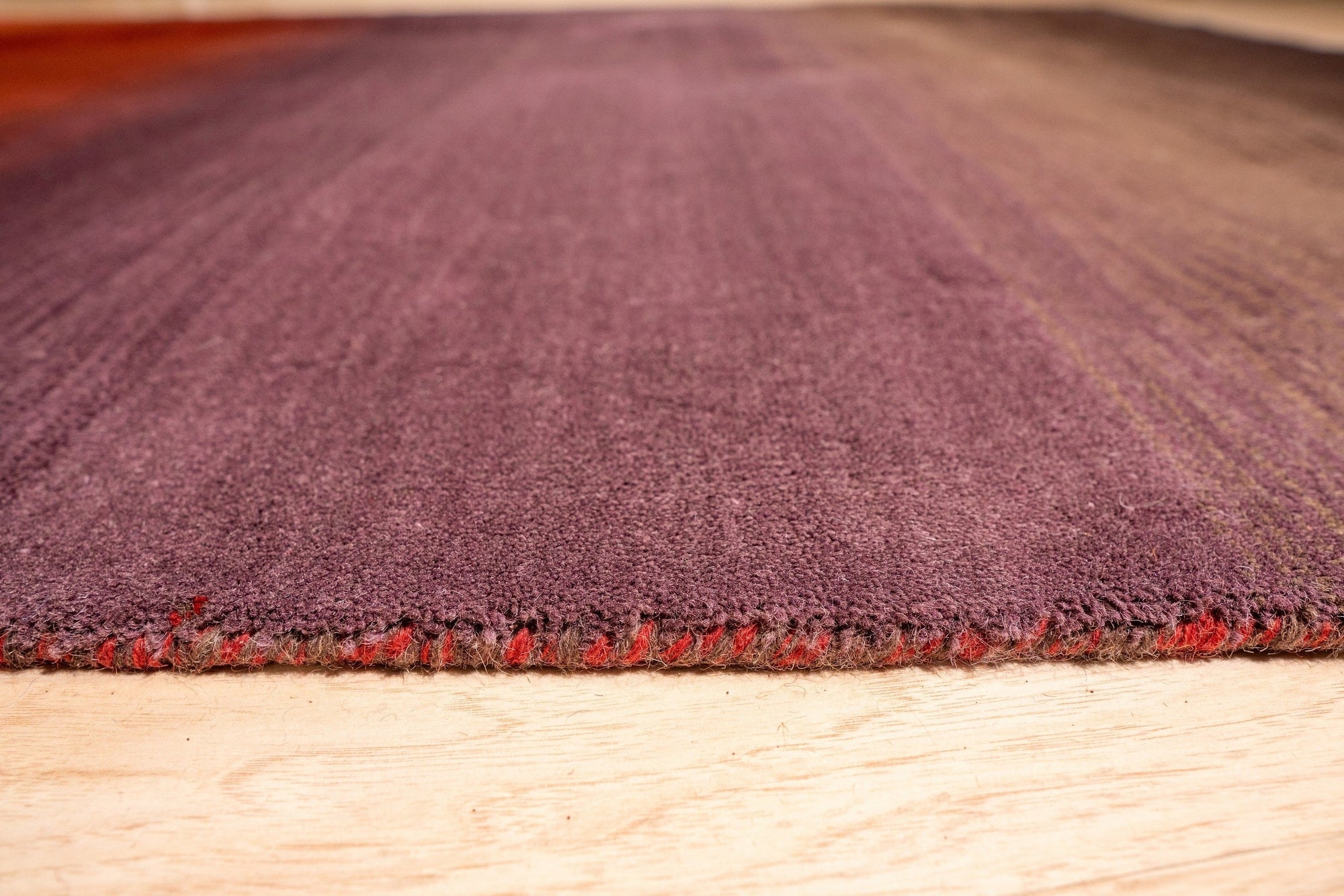 Rhea Unique Multicolor Handmade Wool Rug, vibrant stripes and geometric patterns dance across this wool rug, filling a sunlit living room with warmth and eclectic style.