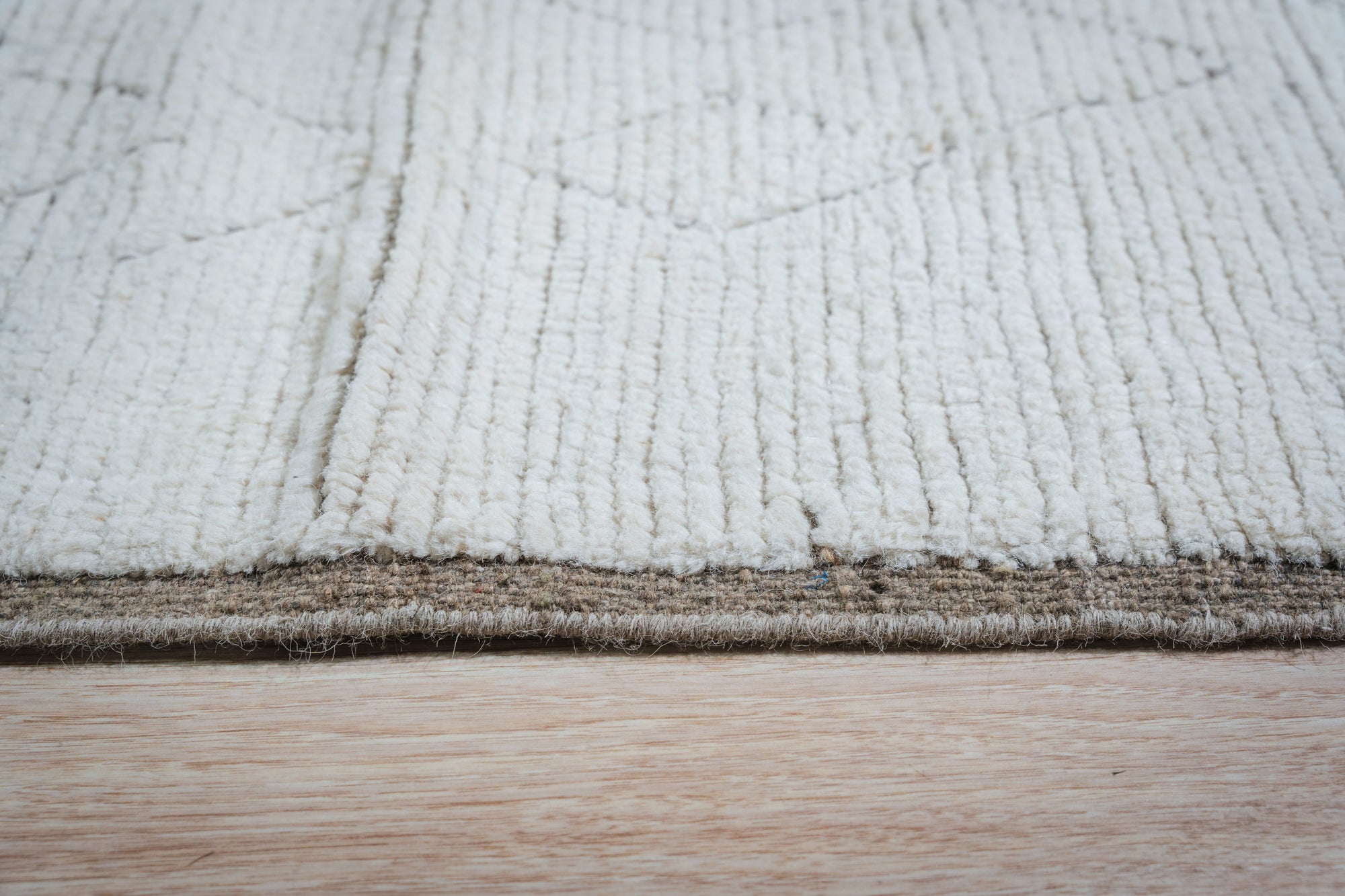 Marrakech Serenity Ivory Rug displayed in a bright living room setting. Woven rug features an intricate geometric pattern in muted ivory and beige tones, creating a calming, textured foundation for the space.