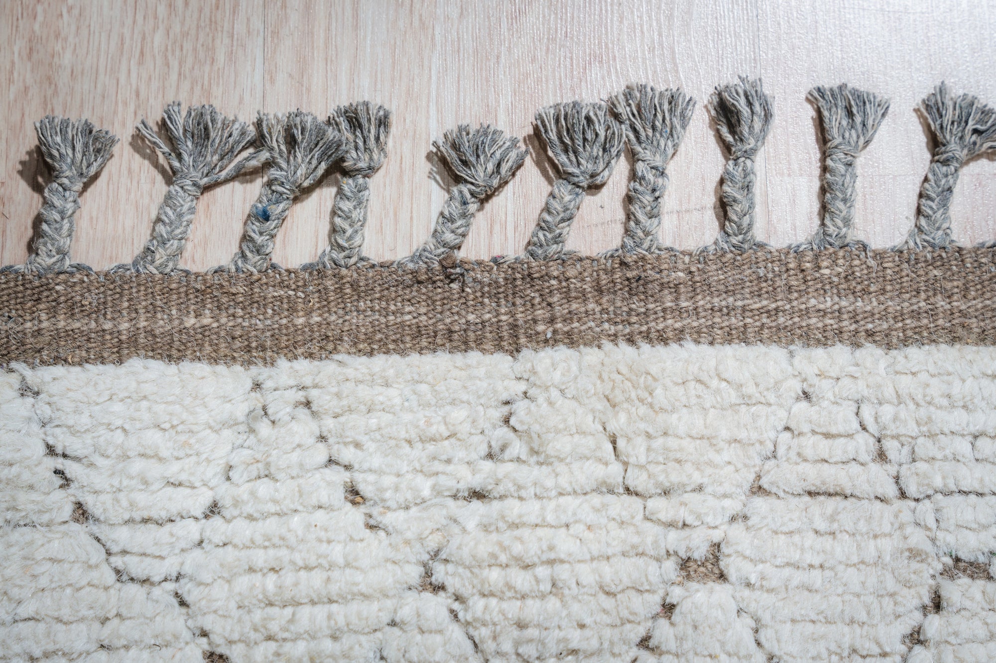 Marrakech Serenity Ivory Rug in a sun-drenched living room; soft ivory tones and subtle textured weave create a calming, bohemian vibe beneath a light wood coffee table.