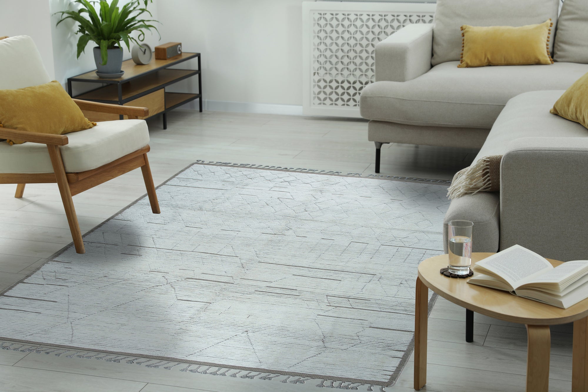 Marrakech Serenity Ivory Rug gracing a warmly lit living room; soft ivory tones and subtle geometric patterns evoke a sense of calm sophistication on a hardwood floor.