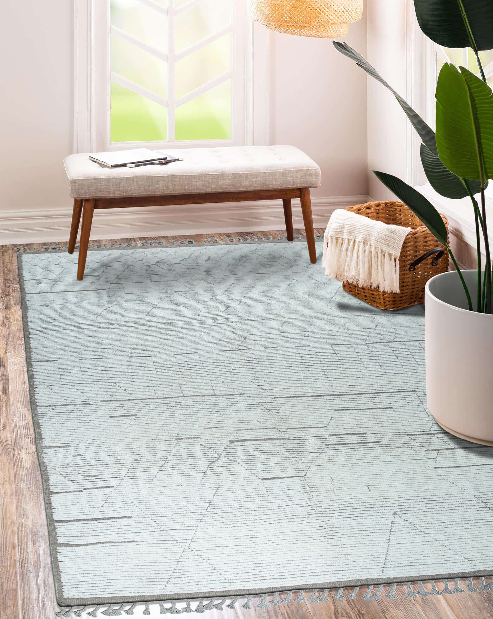 Marrakech Serenity Ivory Rug, its soft ivory tones and subtle geometric patterns grounding a bright, minimalist living room with neutral furniture and ample natural light.