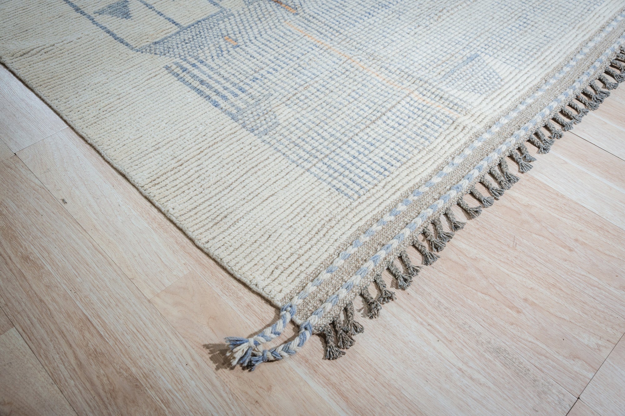 Here's the alt text based on the guidelines and the provided information:
 
 Aurora Multicolor Marrakech Rug sprawls across a light wood floor, its vibrant hues and intricate geometric patterns evoking the bustling souks of Marrakech. Warm oranges, cool blues, and earthy browns blend in a hand-knotted construction, offering a global bohemian vibe.