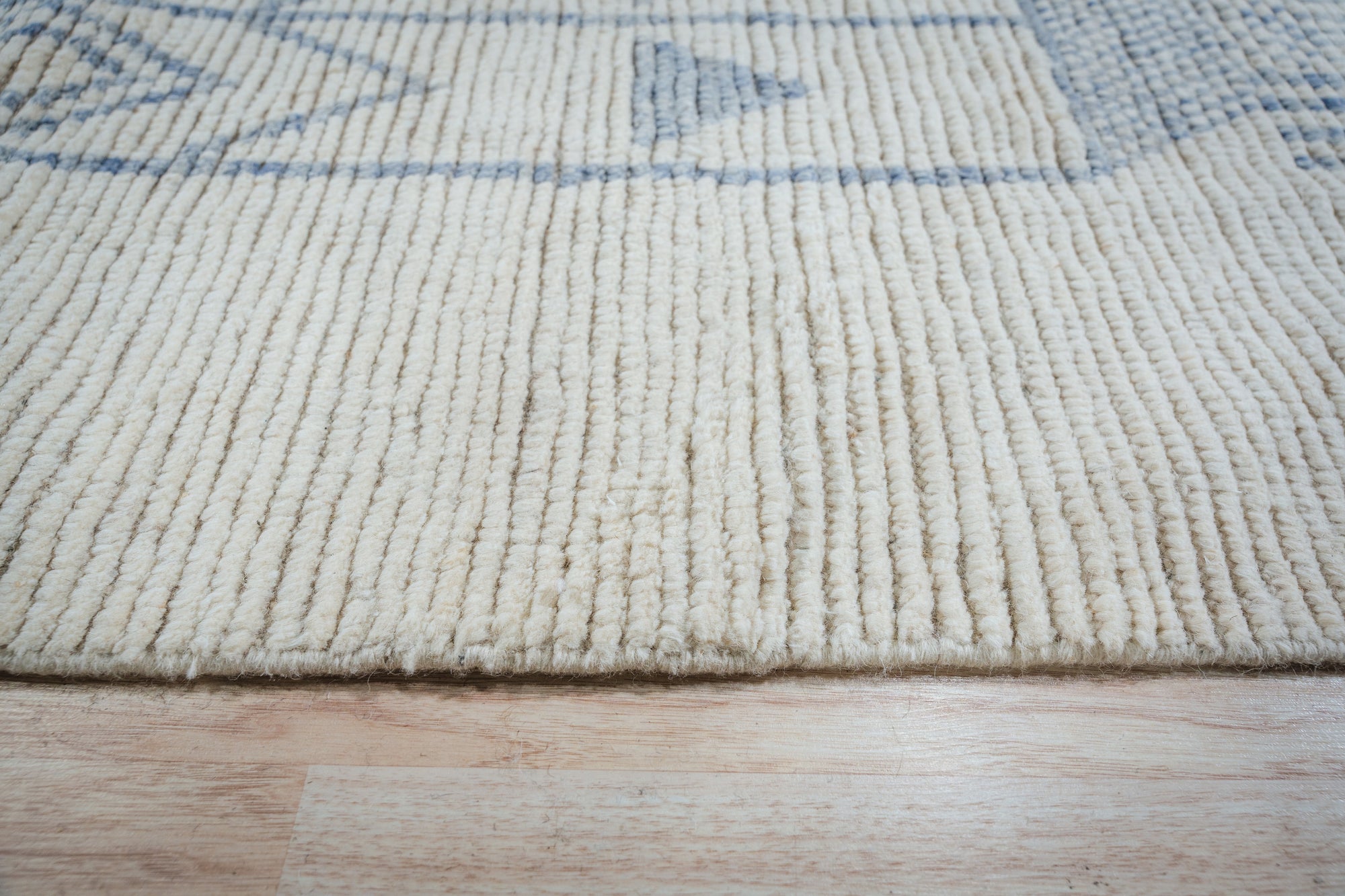 Aurora Multicolor Marrakech Rug, a vibrant splash of color in a sunlit living room, its plush texture inviting touch; showcasing a geometric Moroccan-inspired design against a light hardwood floor.