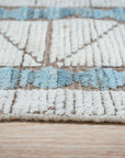 Timeless Marrakech Ivory Hand-Knotted Wool Rug, showcasing a textural, geometric design with subtle variations in ivory, adds warmth to a modern living space.