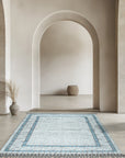 Timeless Marrakech Ivory Hand-Knotted Wool Rug displayed in a bright, modern living room, its intricate geometric design adding warmth to the minimalist space.