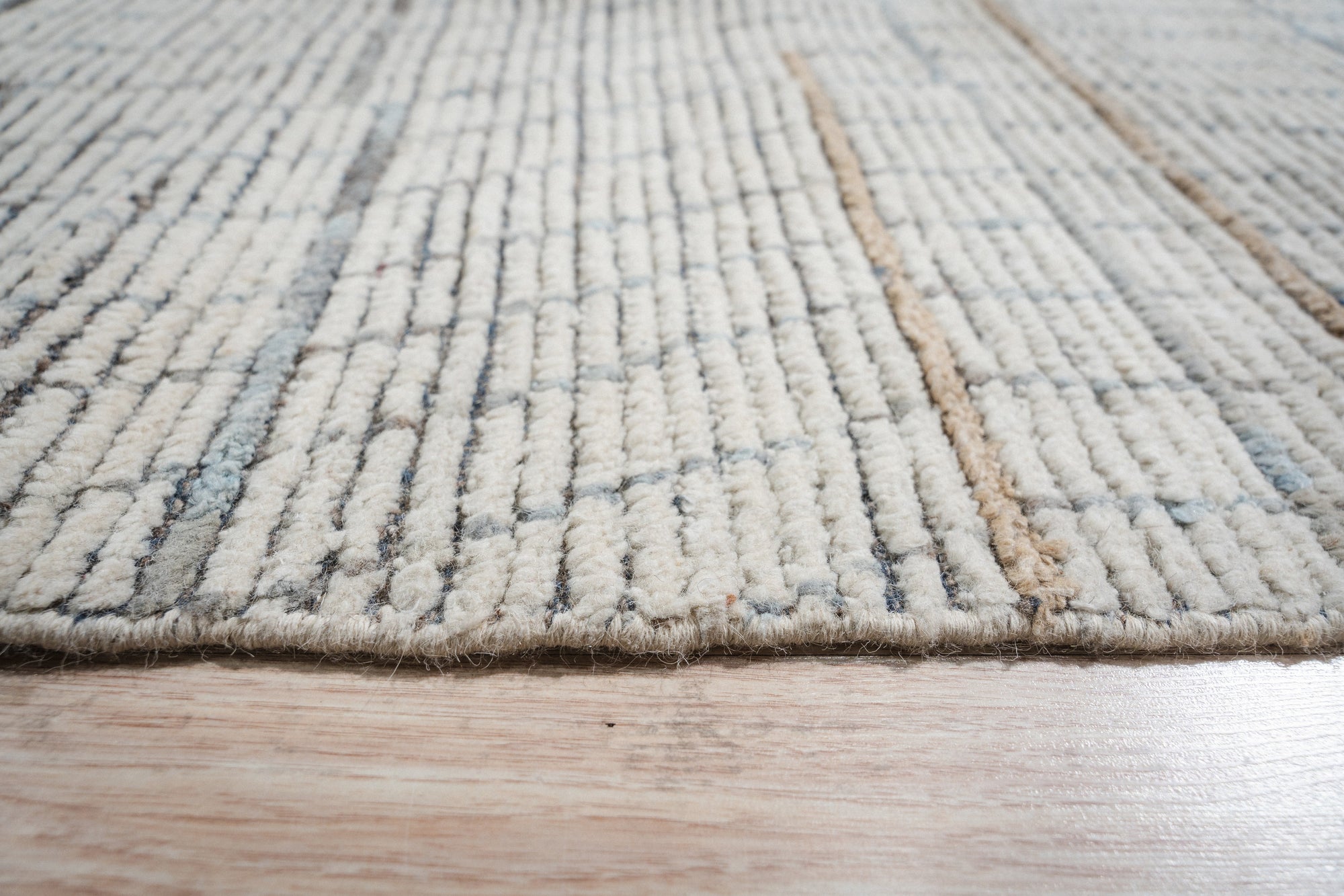 Ornate Marrakech Ivory Hand-Knotted Wool Rug, showcasing intricate geometric patterns in soft ivory tones, lending a touch of global elegance to a modern living space.