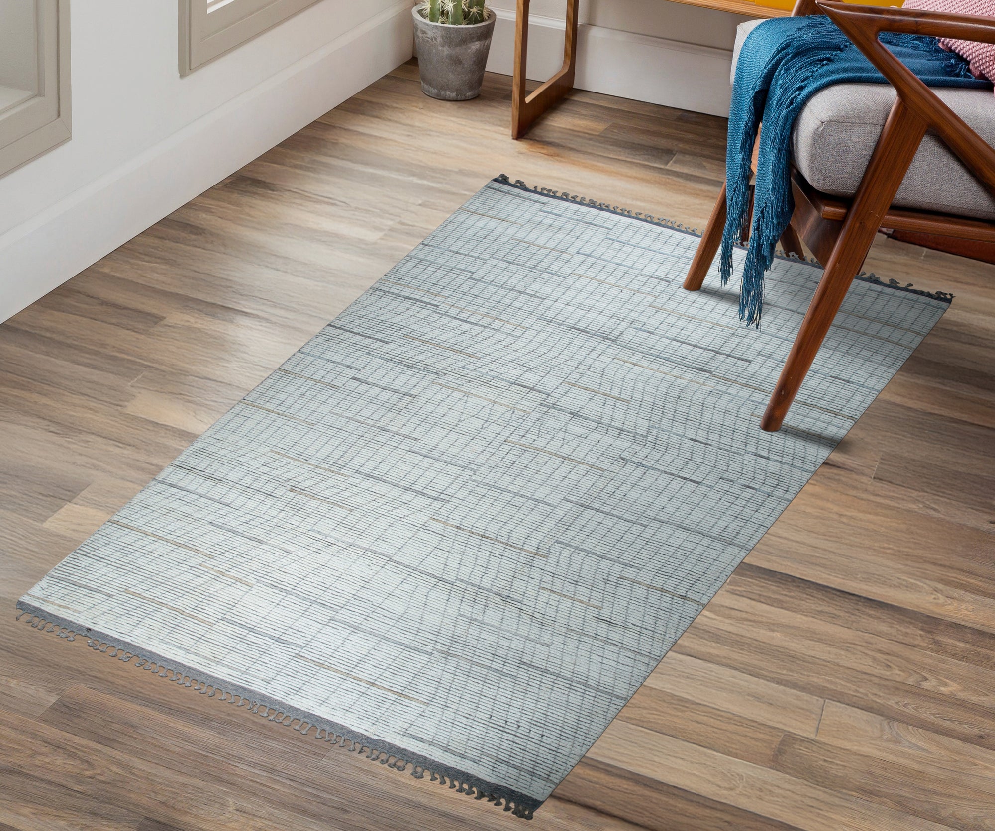 Ornate Marrakech Ivory Hand-Knotted Wool Rug, a neutral-toned wool rug featuring intricate geometric patterns in a bright, sunlit living room setting.