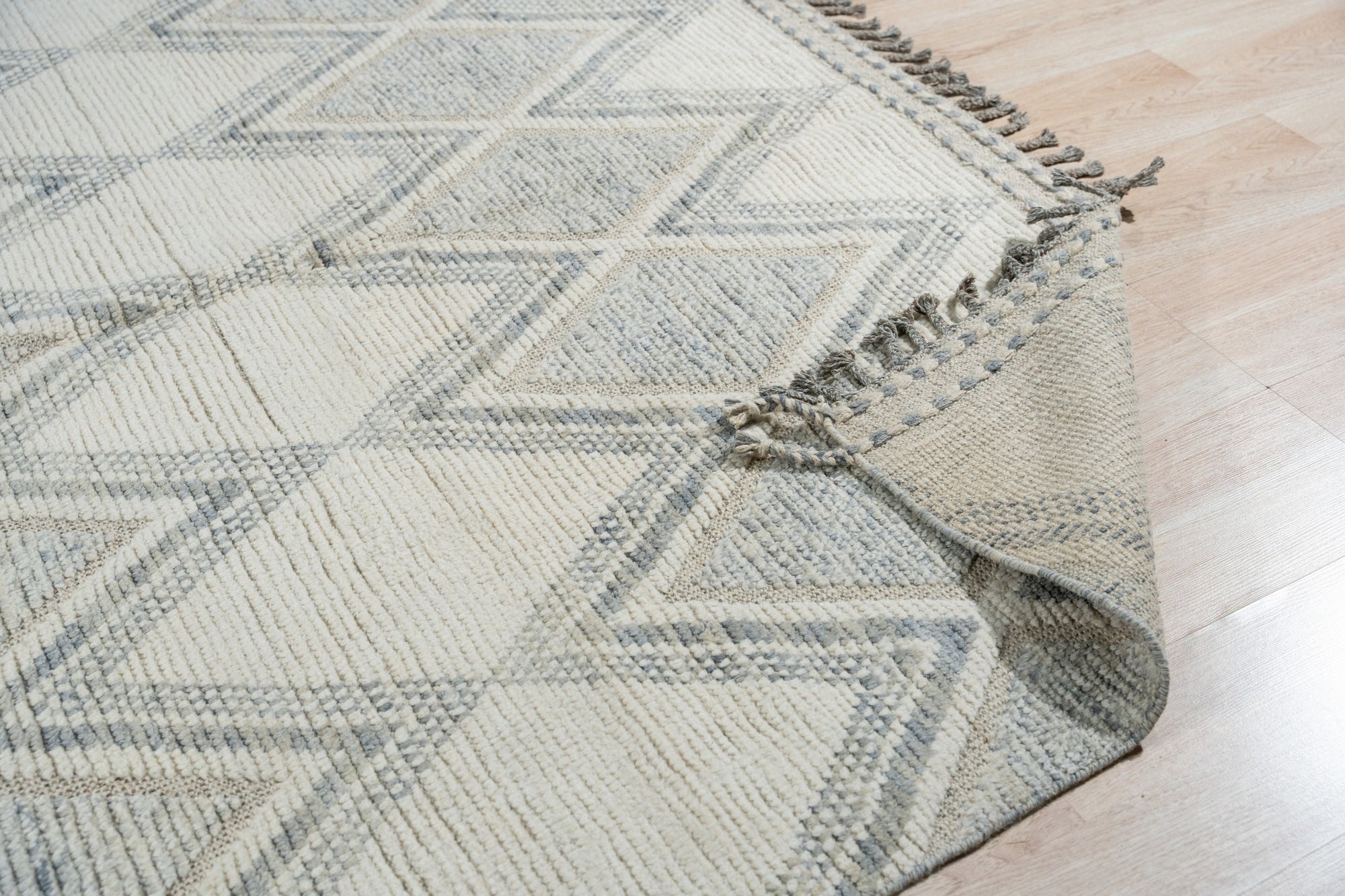 Elegant Marrakech Beige Hand-Knotted Wool Rug, a warm beige wool rug with intricate hand-knotted patterns, lending an air of understated luxury to a softly lit interior.