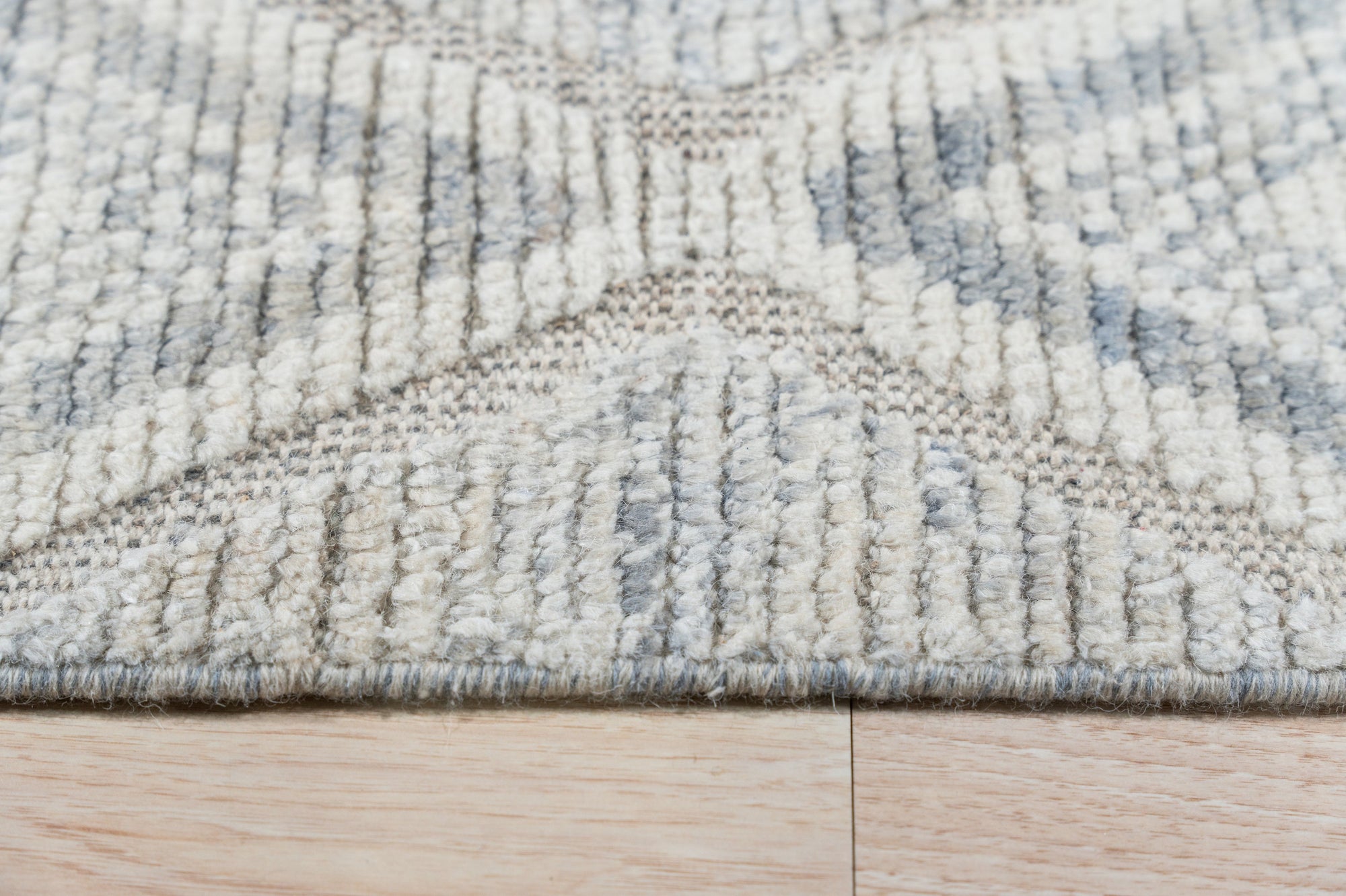 Elegant Marrakech Beige Hand-Knotted Wool Rug, its warm beige tones and intricate hand-knotted details complementing a bright, airy living space.