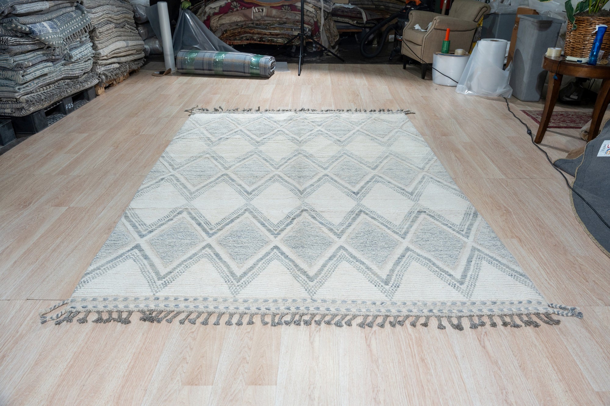 Elegant Marrakech Beige Hand-Knotted Wool Rug, showcasing intricate geometric patterns and soft beige hues, warms a bright living space with natural light.