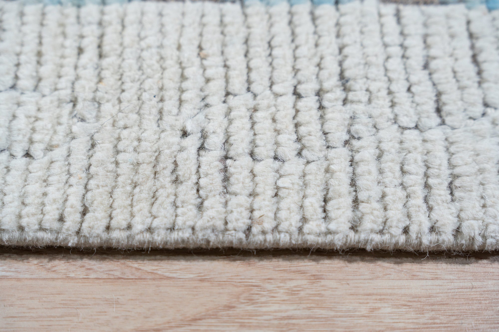 Timeless Marrakech Beige Hand-Knotted Wool Rug, warm beige hues and intricate Moroccan-inspired geometric patterns enrich a living room setting.