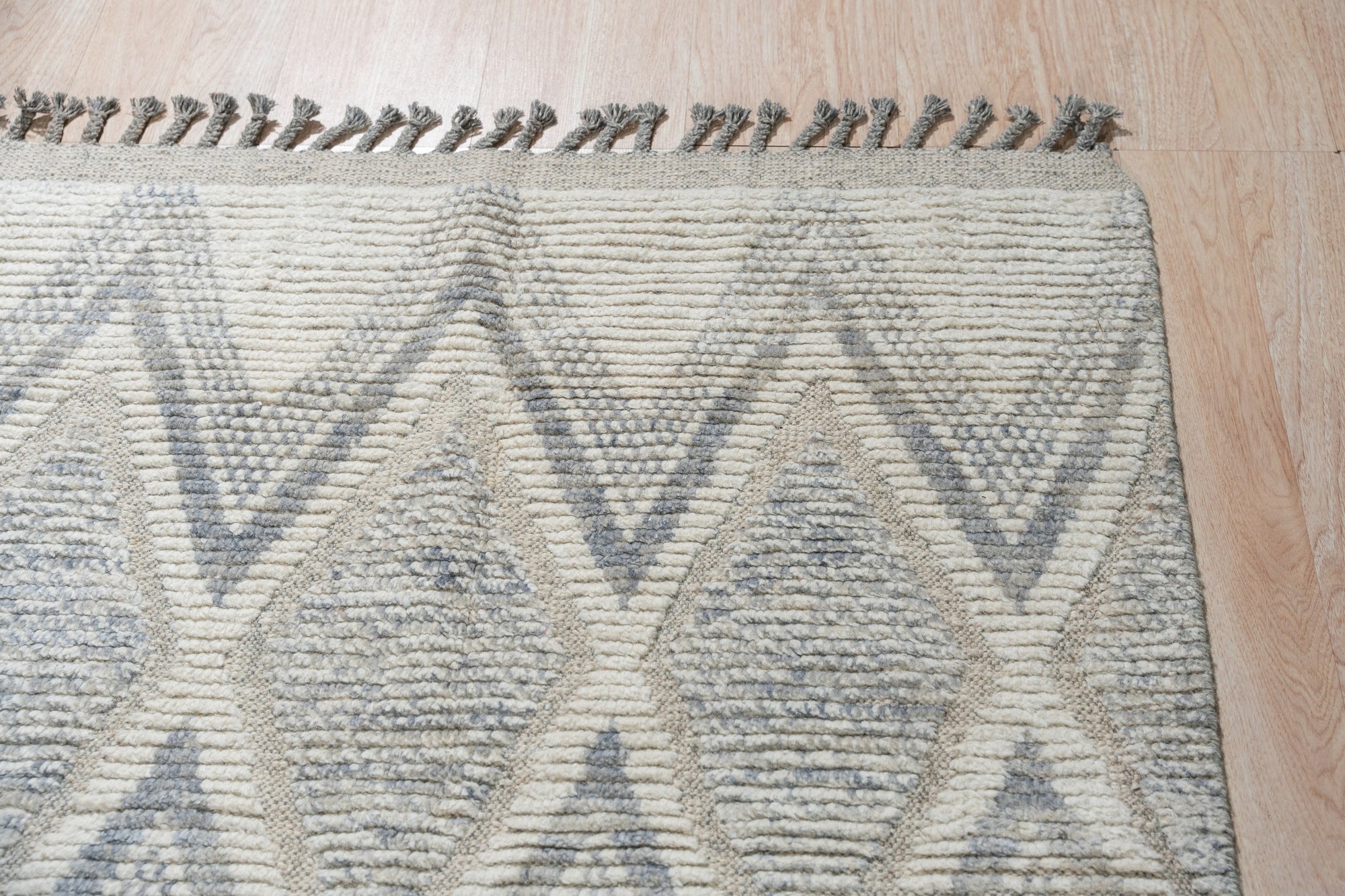 Sophisticated Marrakech Beige Hand-Knotted Wool Rug, a beige wool rug with a traditional Moroccan-inspired design, seen in a bright, airy living space.