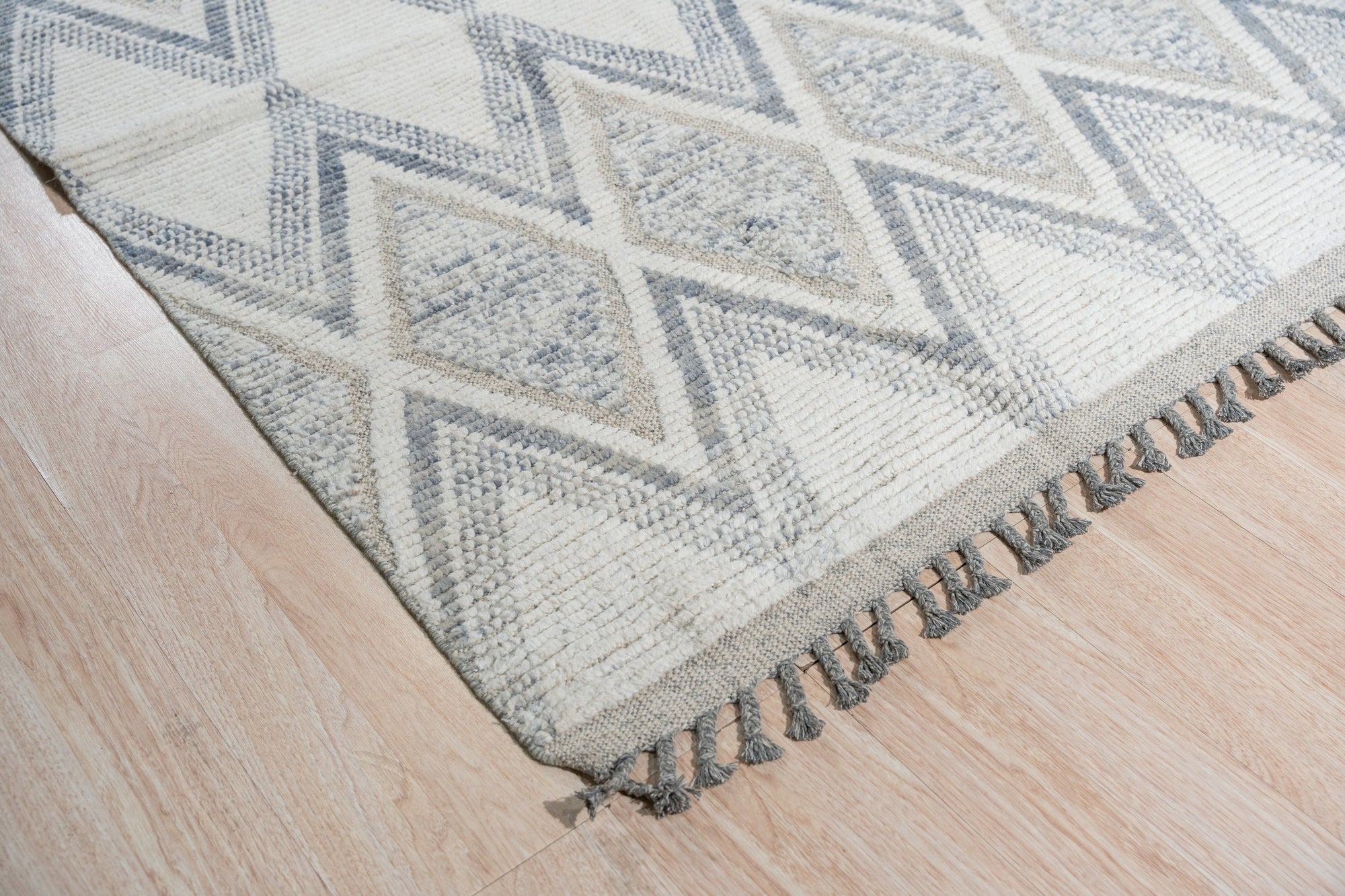 Sophisticated Marrakech Beige Hand-Knotted Wool Rug, warm beige tones and intricate geometric patterns create a cozy and inviting atmosphere, seen in a styled living room setting.