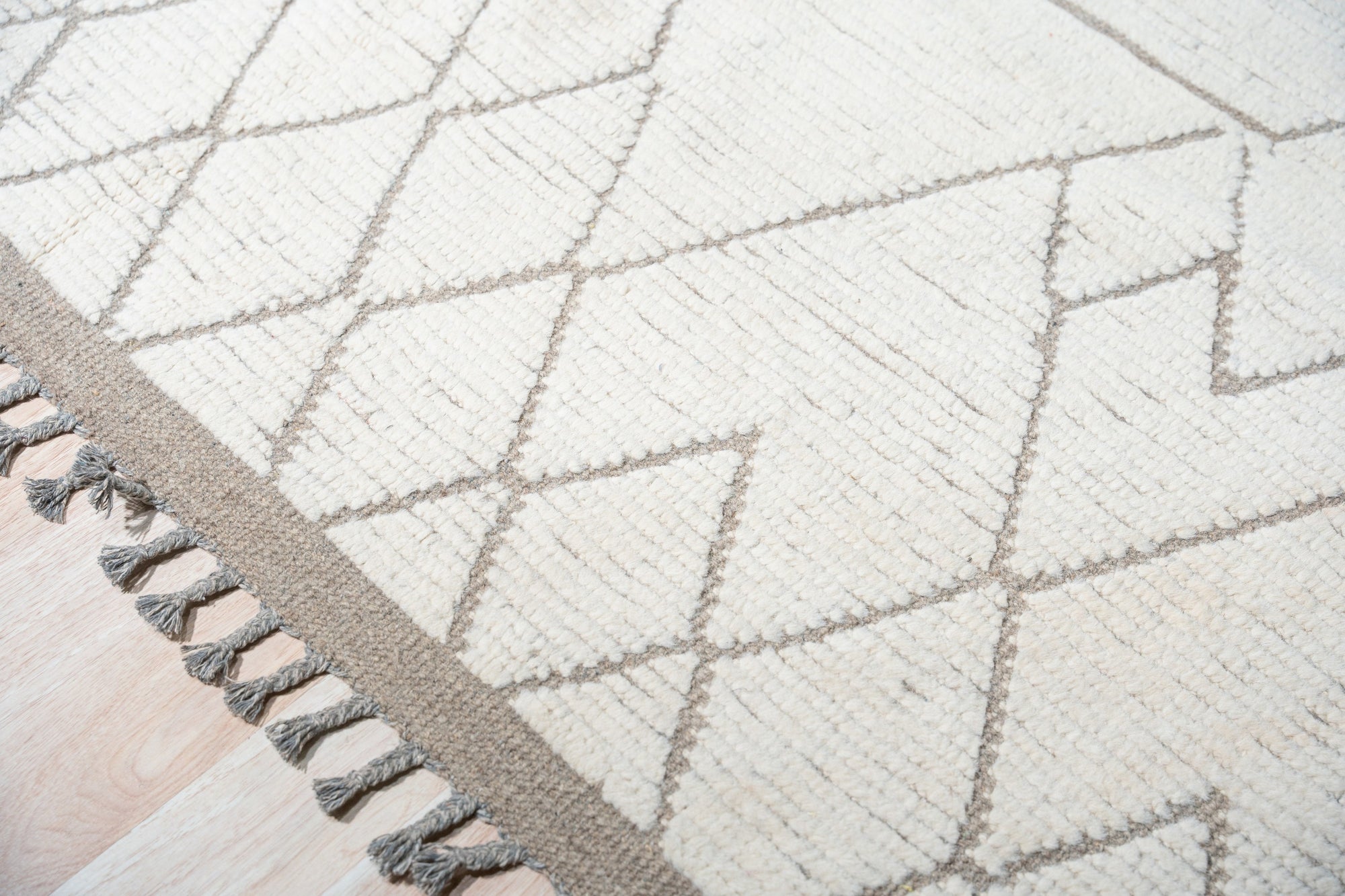 Refined Marrakech Beige Hand-Knotted Wool Rug, showcasing its intricate hand-knotted construction and subtle beige tones in a warmly lit living space.