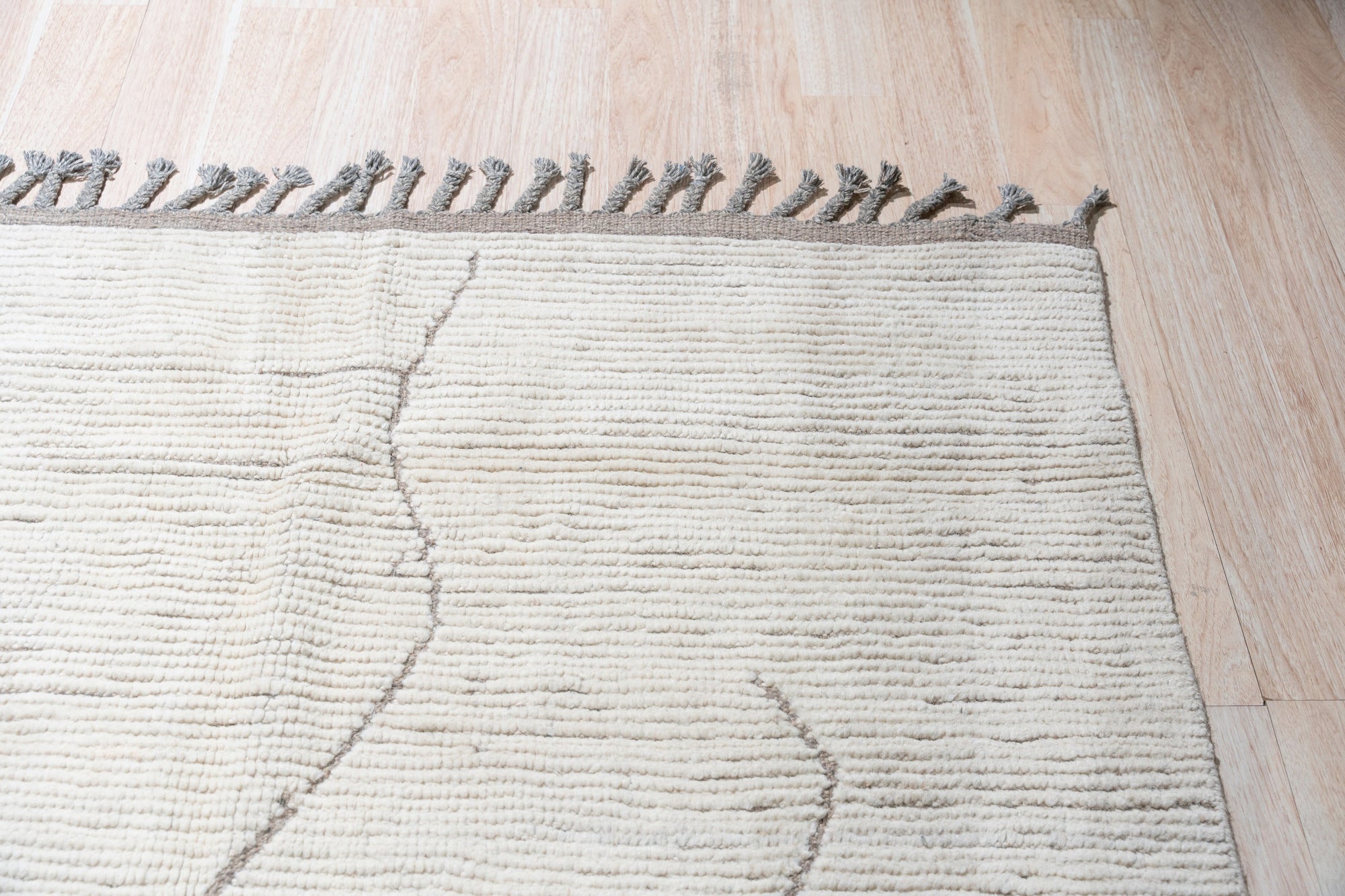 Vintage Marrakech Beige Hand-Knotted Wool Rug, showcasing intricate geometric patterns in soft beige tones, grounding a bright living space with layered textures.