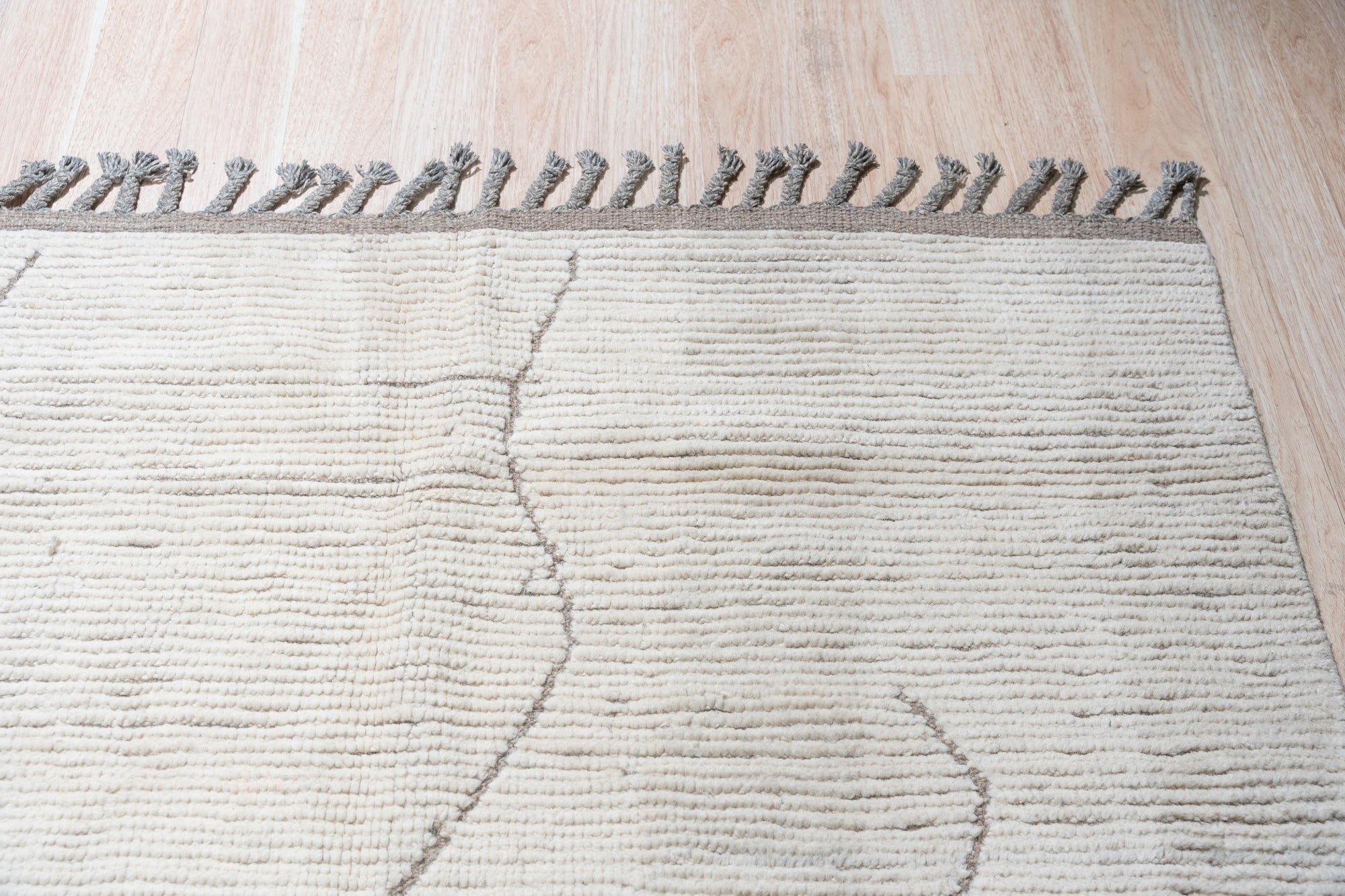 Vintage Marrakech Beige Hand-Knotted Wool Rug, a subtle beige wool rug with a classic Moroccan-inspired design, lies flat, its intricate knotwork visible.