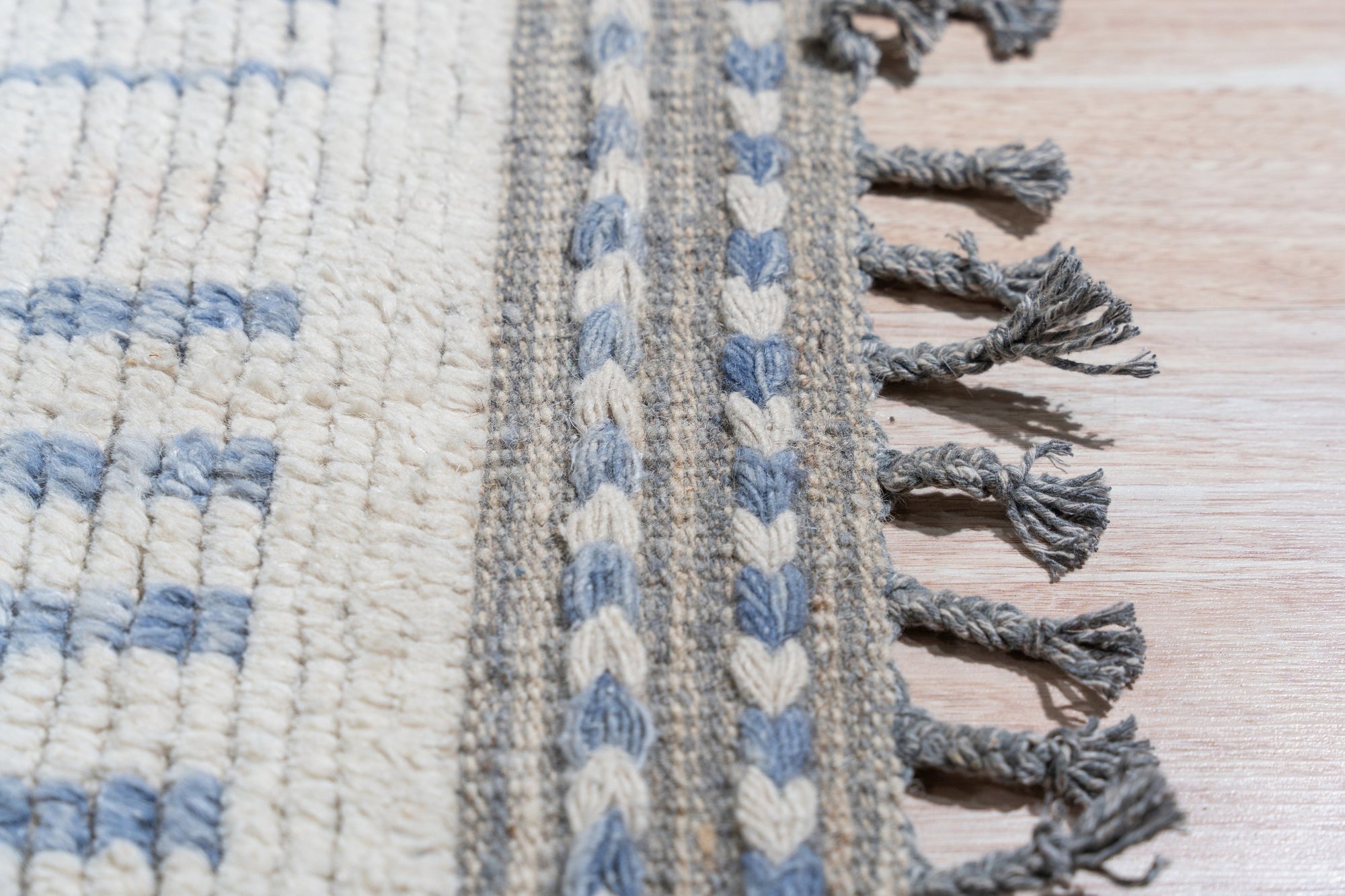 Contemporary Marrakech Ivory Hand-Knotted Wool Rug, showcasing its textured ivory wool pile and subtle geometric pattern, anchors a modern living space with warmth and understated elegance.