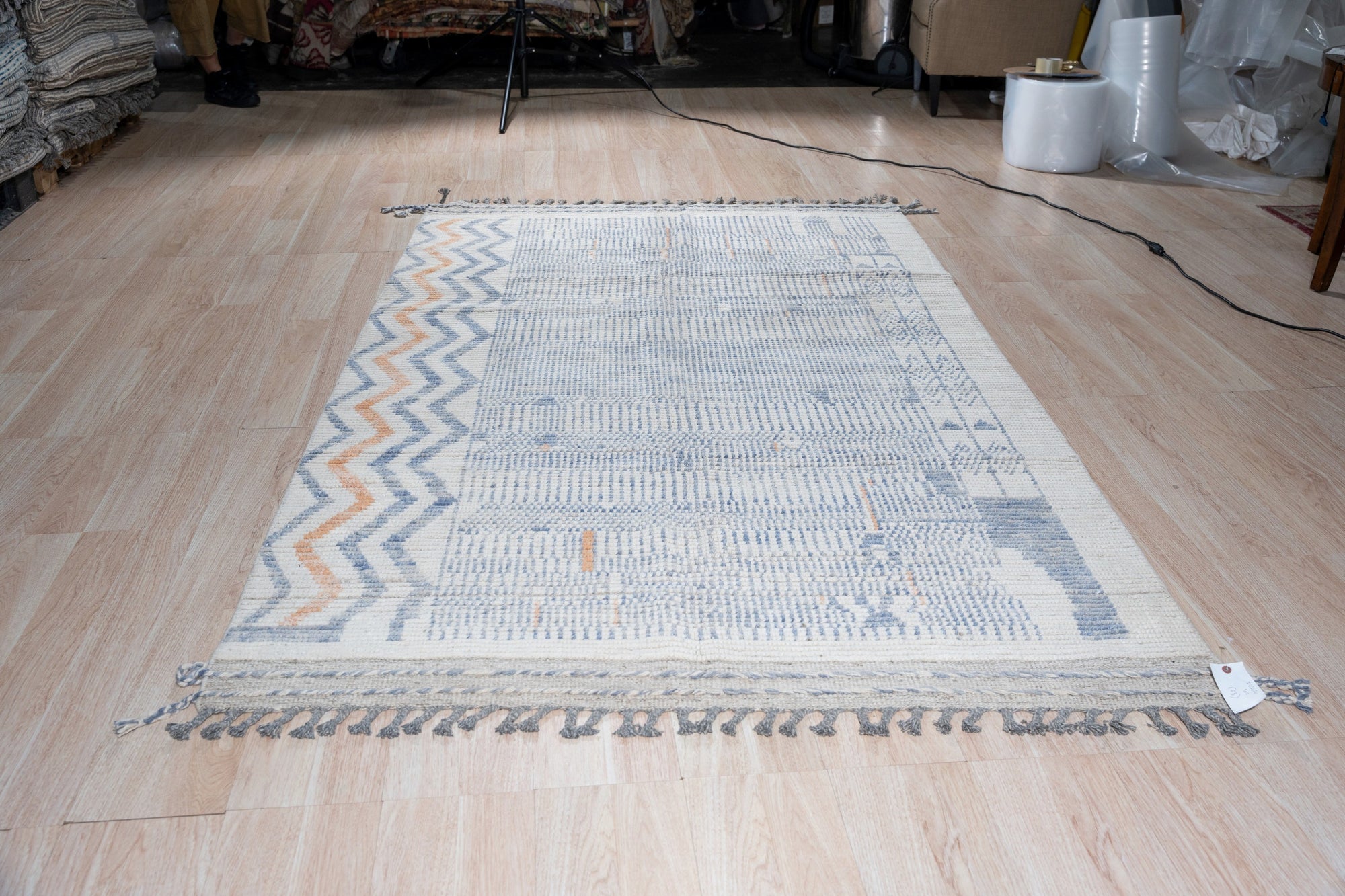 Subtle Marrakech Ivory Hand-Knotted Wool Rug, its textured ivory pile adding warmth to a minimally furnished living room with natural light.