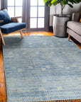 Classic Marrakech Blue Hand-Knotted Wool Rug, featuring intricate geometric patterns in varying shades of blue, laid on a light wooden floor, creating a vibrant yet calming focal point.
