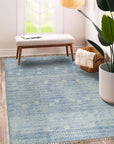 Classic Marrakech Blue Hand-Knotted Wool Rug, blending deep blues and intricate patterns, laid on a warm wood floor in a sunlit room, evoking Moroccan charm.