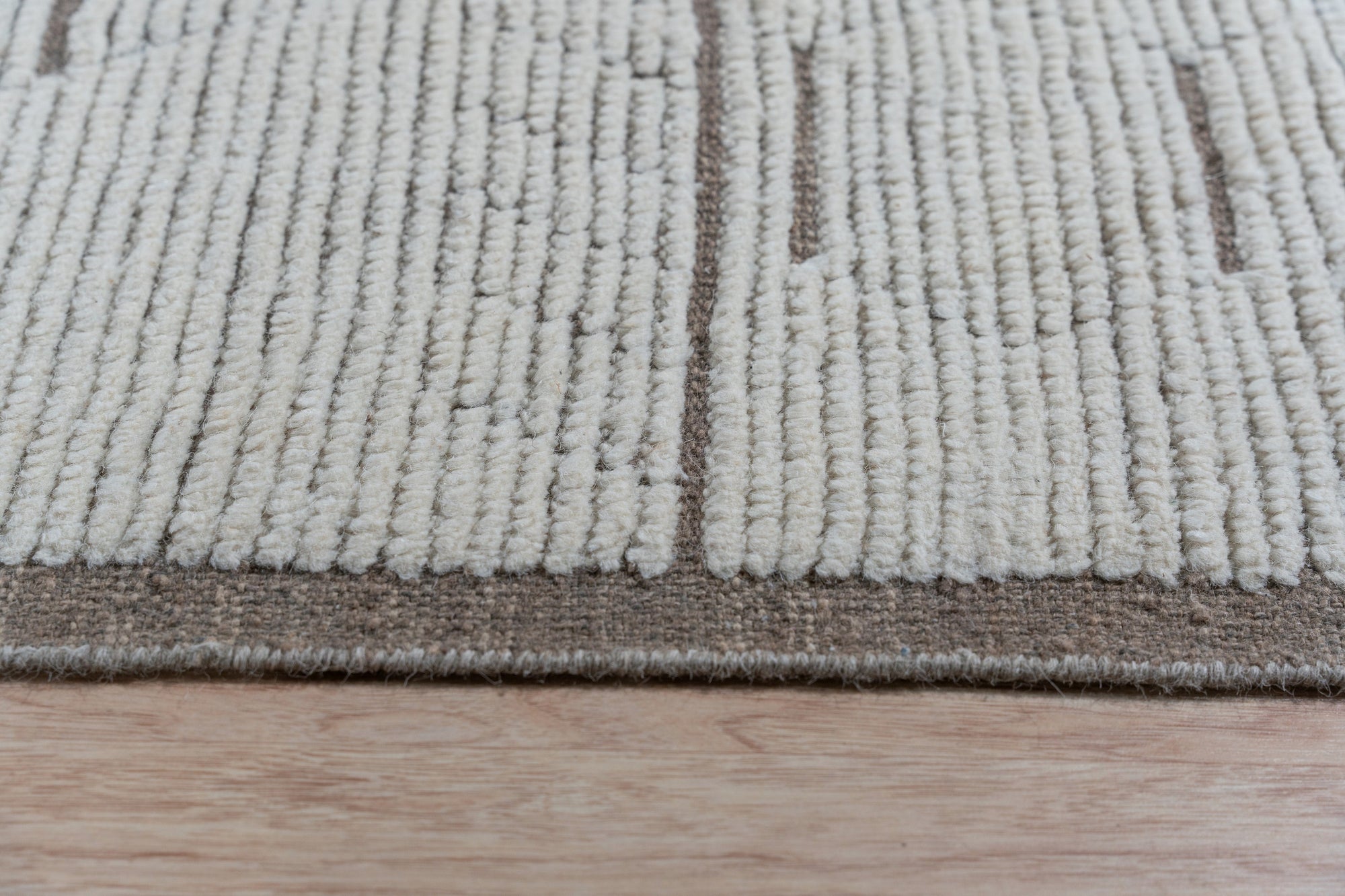 Sophisticated Marrakech Brown Hand-Knotted Wool Rug, warm browns and subtle patterns enriching a living space, showcasing the rug's texture and artisanal construction.