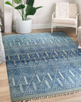 Refined Marrakech Blue Hand-Knotted Wool Rug, featuring a complex geometric pattern in shades of blue and cream, displayed on a light hardwood floor.