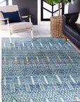 Timeless Marrakech Blue Hand-Knotted Wool Rug, a mesmerizing sapphire and indigo wool rug featuring intricate geometric patterns inspired by Moroccan design, enriching a warmly lit living space.