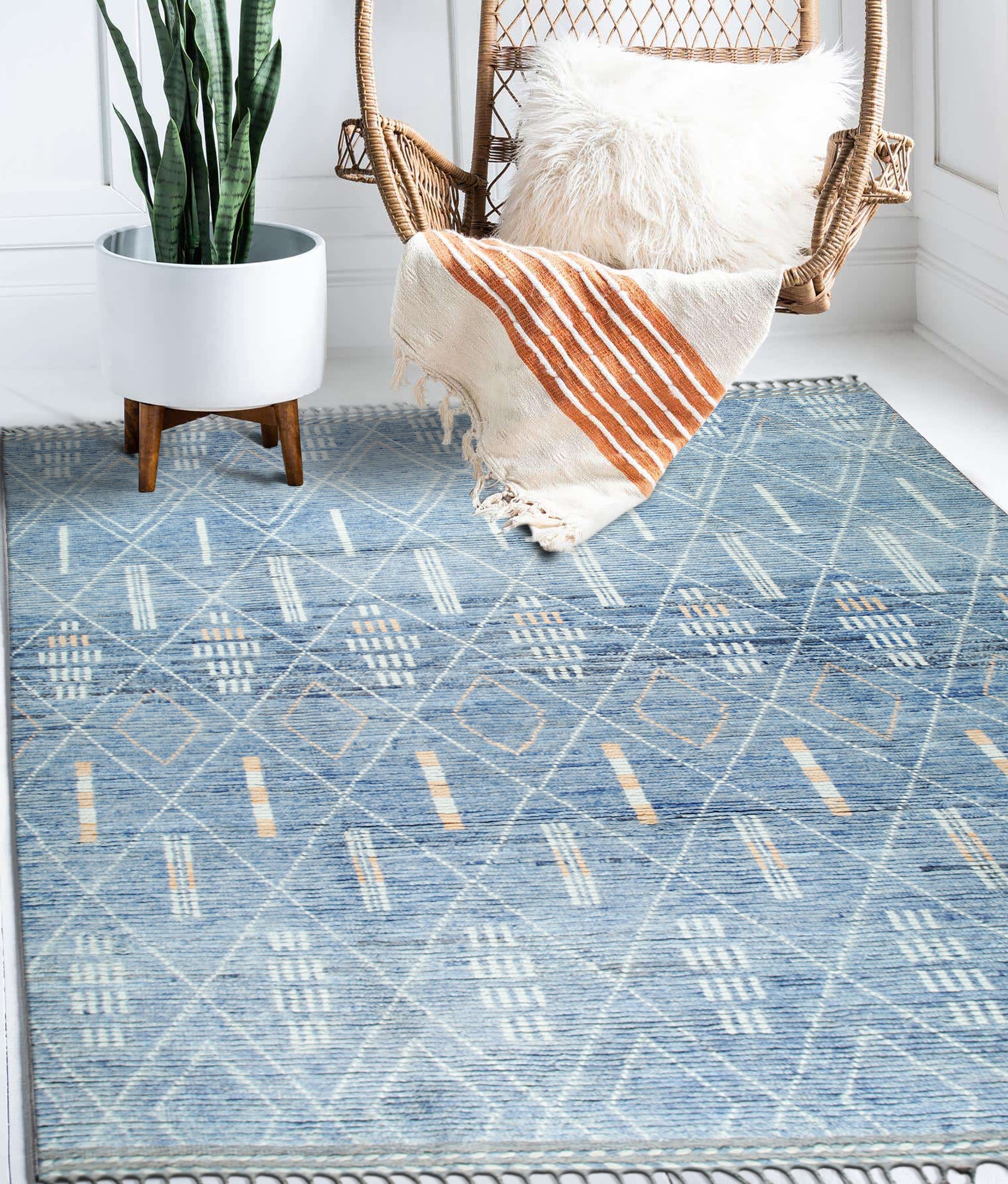 Graceful Marrakech Blue Hand-Knotted Wool Rug, showcased in a bright living room setting. Detailed wool texture and intricate Marrakech-inspired patterns are visible under natural light.