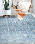 Graceful Marrakech Blue Hand-Knotted Wool Rug, showcased in a bright living room setting. Detailed wool texture and intricate Marrakech-inspired patterns are visible under natural light.