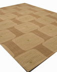Brenda Kira Green Hand Tufted Wool Rug, a textured field of verdant green wool with subtle variations in tone, enhancing the floor in a warmly lit interior space.